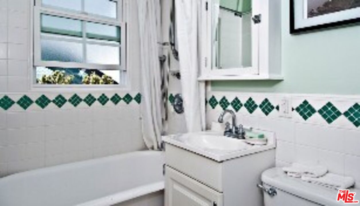 2318 Strongs Drive Venice, CA 90291 - Photo 8 of 19 a bathroom with a granite countertop sink and a mirror