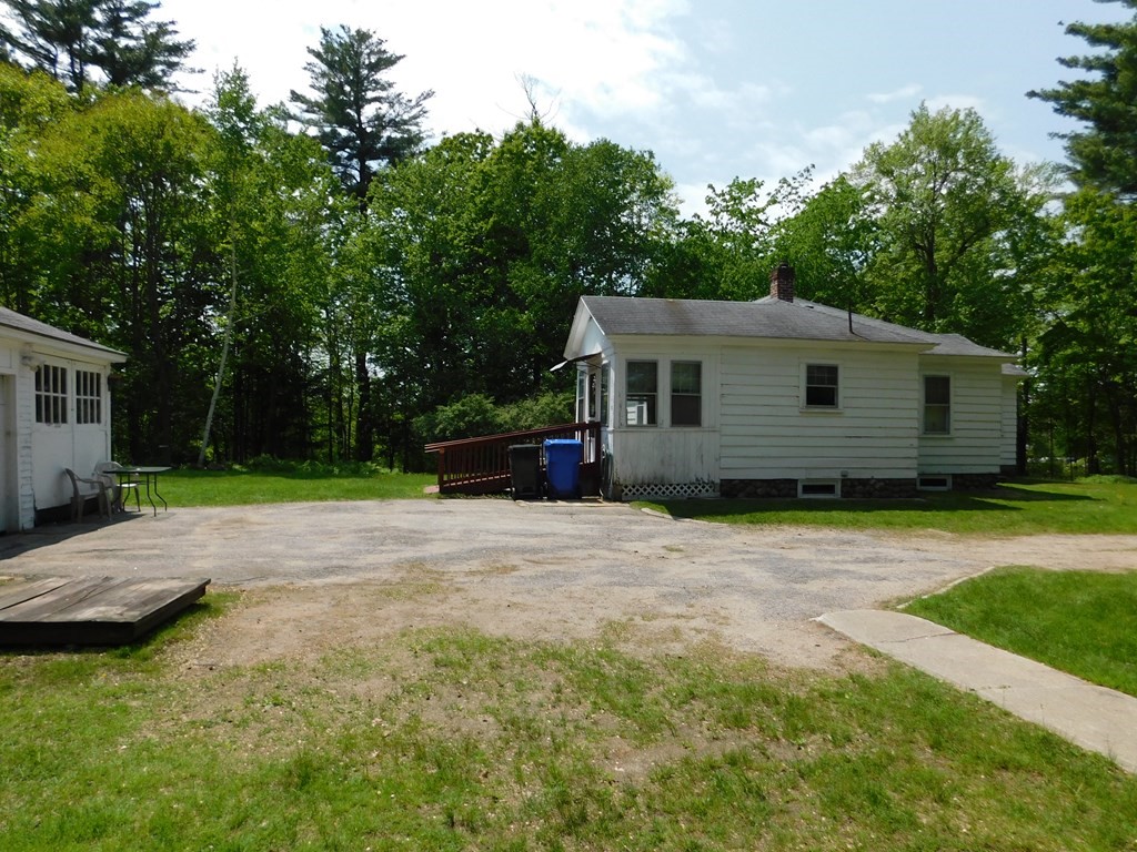 225 Rockingham Road Londonderry, NH 03053 - Photo 8 of 28 a front view of a house with a yard and trees