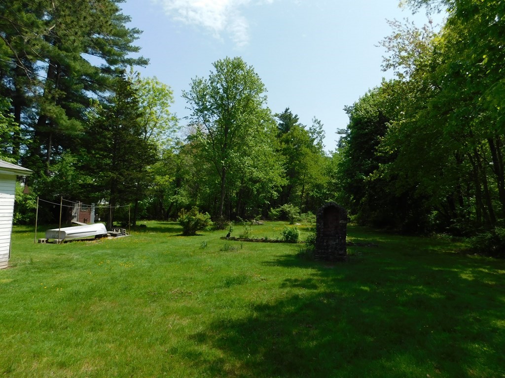 225 Rockingham Road Londonderry, NH 03053 - Photo 10 of 28 a backyard of a house with a table and plants