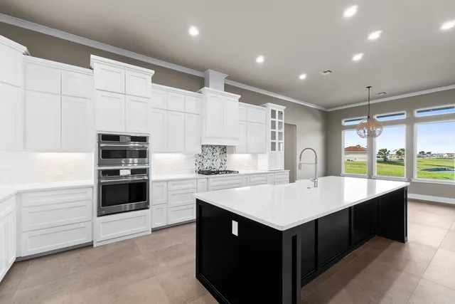 a kitchen with a sink stove and cabinets