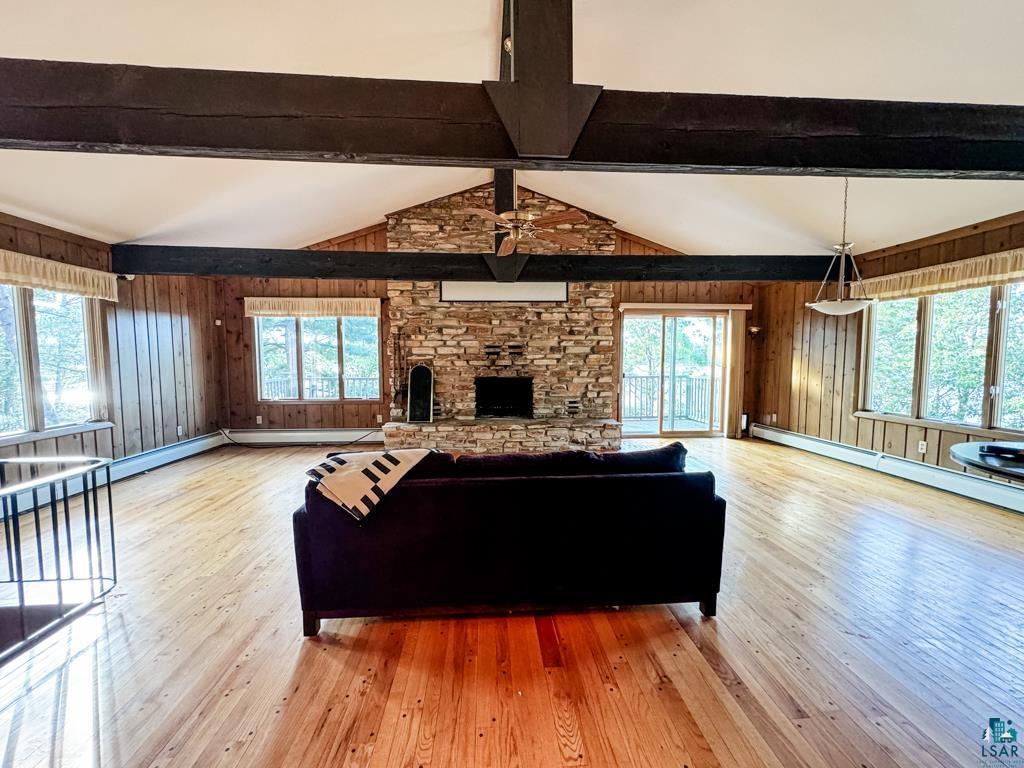 N13431 County Line Road Minong, WI 54859 - Photo 16 of 42 Living room featuring ceiling fan, hardwood / wood-style flooring, plenty of natural light, and a fireplace