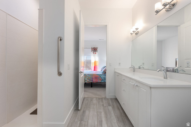 4708 Martin Drive St. George, UT 84790 - Photo 17 of 28 Bathroom with connected bathroom, light wood-style floors, double vanity, and walk in shower