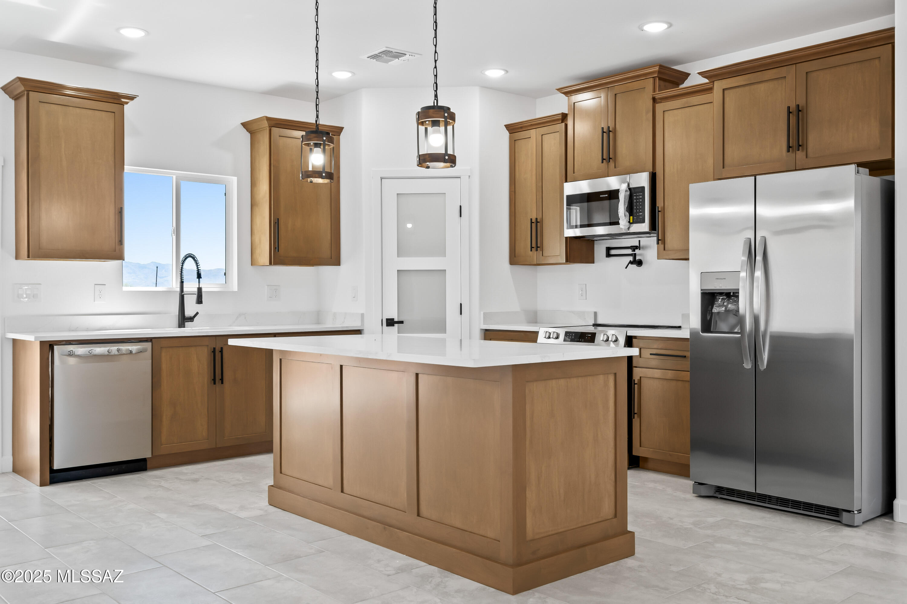 1667 Ave Calamar Rio Rico, AZ 85648 - Photo 11 of 33 a kitchen with stainless steel appliances granite countertop a refrigerator a sink a stove and oven