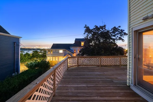 a view of balcony with wooden floor and fence