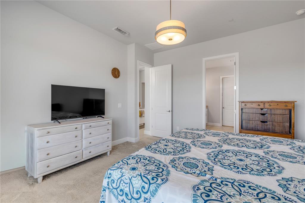 246 Azure Mist Way Daytona Beach, FL 32124 - Photo 12 of 33 a bedroom with a bed and flat screen tv