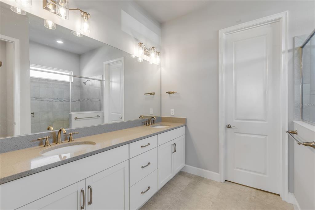 246 Azure Mist Way Daytona Beach, FL 32124 - Photo 13 of 33 a bathroom with a double vanity sink and a mirror