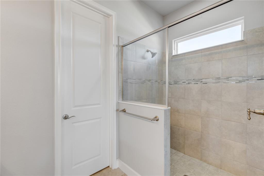 246 Azure Mist Way Daytona Beach, FL 32124 - Photo 14 of 33 a bathroom with a glass shower door