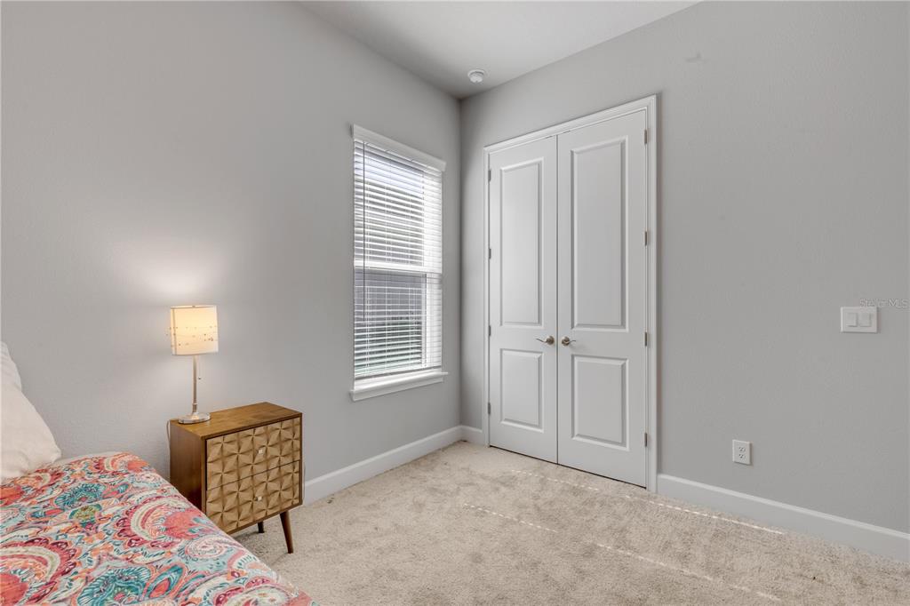 246 Azure Mist Way Daytona Beach, FL 32124 - Photo 16 of 33 a bedroom with a bed and a window