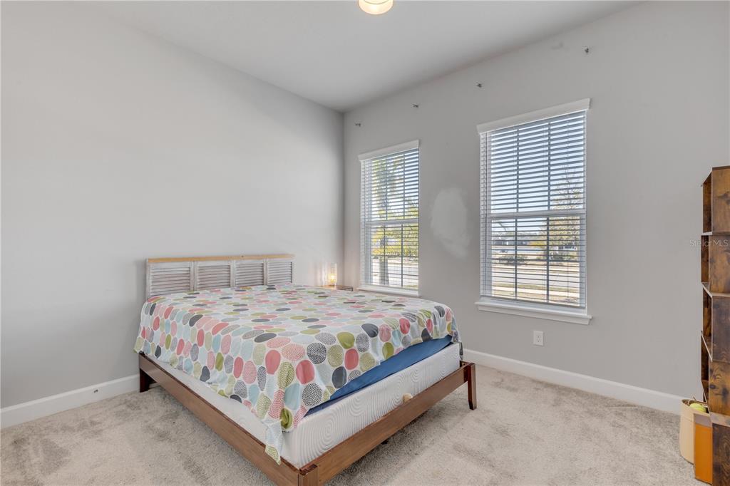 246 Azure Mist Way Daytona Beach, FL 32124 - Photo 17 of 33 a bedroom with a bed lamp and window