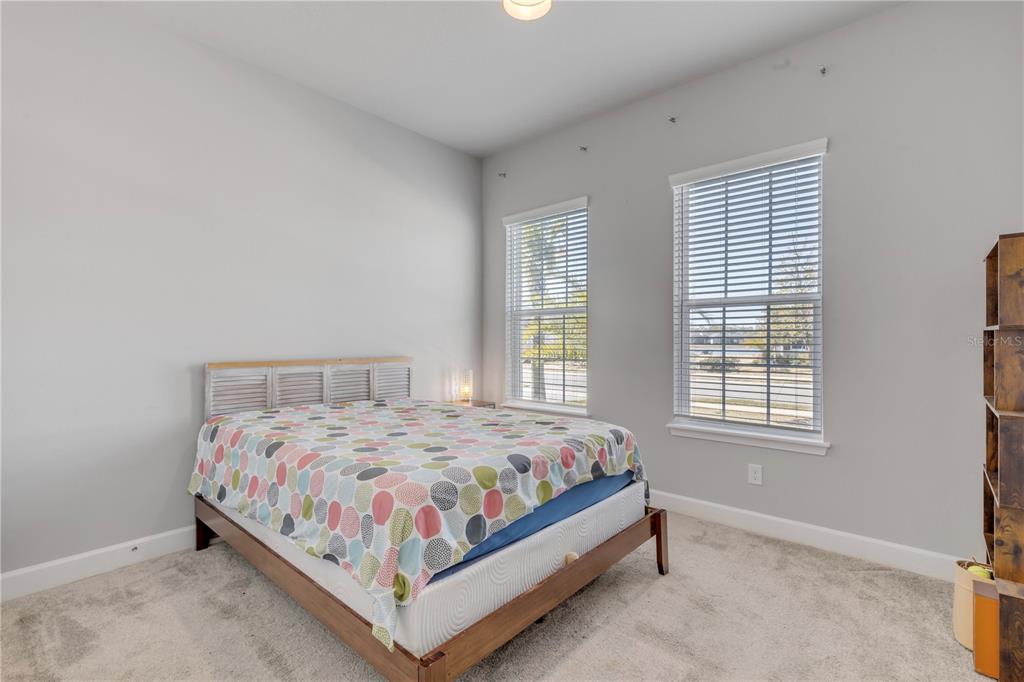 246 Azure Mist Way Daytona Beach, FL 32124 - Photo 17 of 33 a bedroom with a bed lamp and window