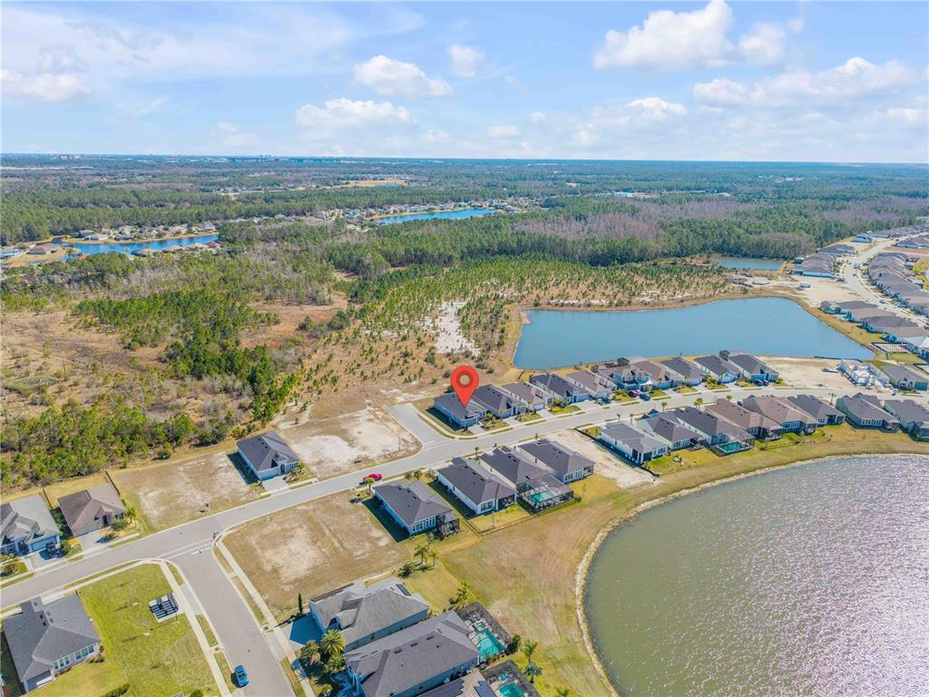 246 Azure Mist Way Daytona Beach, FL 32124 - Photo 32 of 33 an aerial view of a house with a lake view