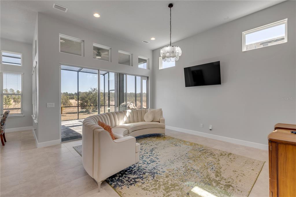 246 Azure Mist Way Daytona Beach, FL 32124 - Photo 4 of 33 a living room with furniture a flat screen tv and a large window