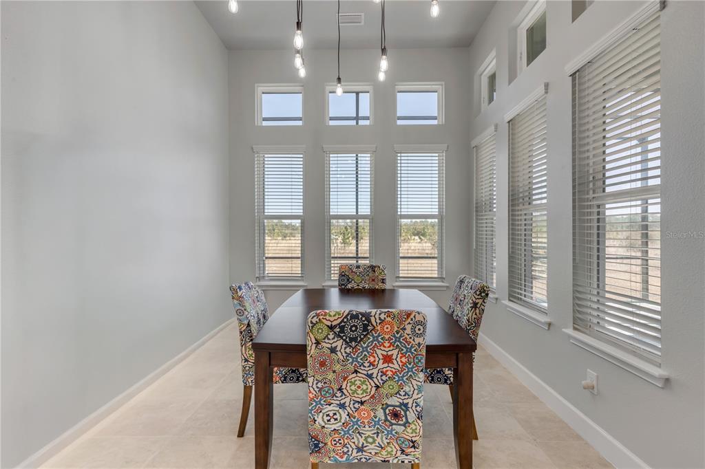 246 Azure Mist Way Daytona Beach, FL 32124 - Photo 10 of 33 a view of a dining room with furniture and a chandelier
