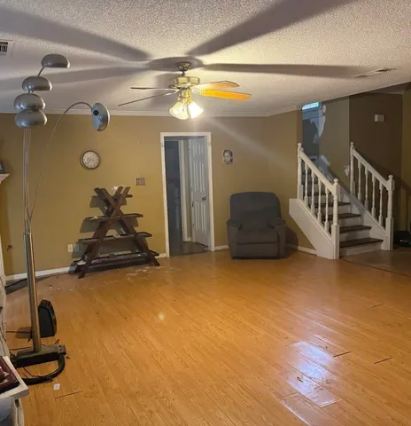 a hallway with a view of gym equipment