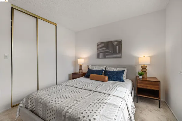 a bedroom with a bed and a night stand