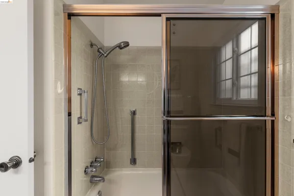 a bathroom with a glass shower door