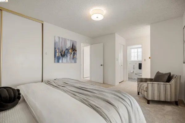 a bedroom with a bed and glass window