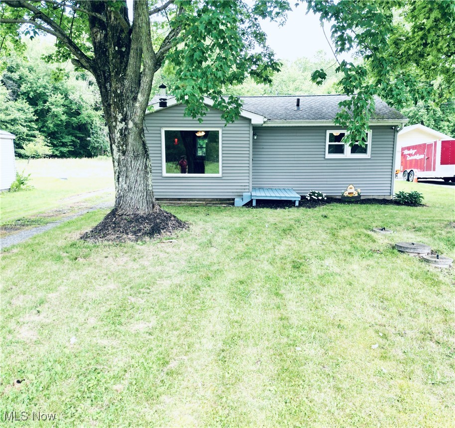 6092 Shaffer Road Northwest Warren, OH 44481 - Photo 27 of 30 Back of house with a yard and roof with shingles