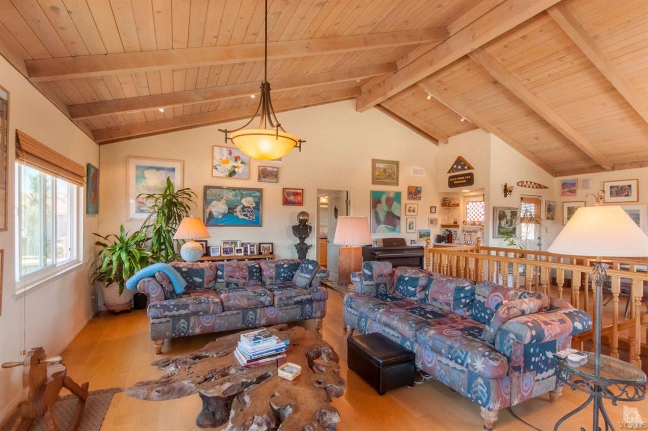 5241 Beachcomber Street Oxnard, CA 93035 - Photo 11 of 21 a living room with furniture a chandelier and a dining table