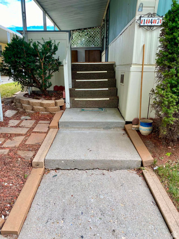 1111 North 2000 West, Unit 147 Ogden, UT 84404 - Photo 2 of 12 Concrete walkway leading to carpeted entry steps