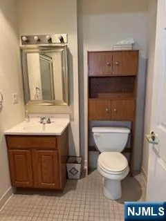 a bathroom with a toilet a sink and mirror