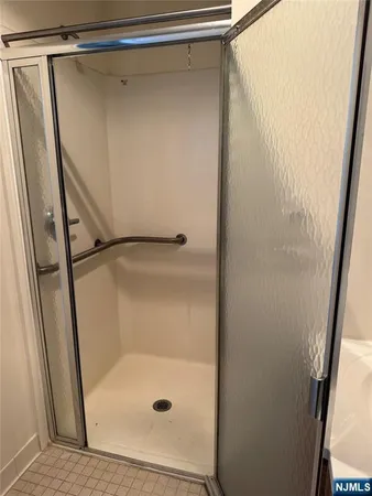 a bathroom with a glass shower door