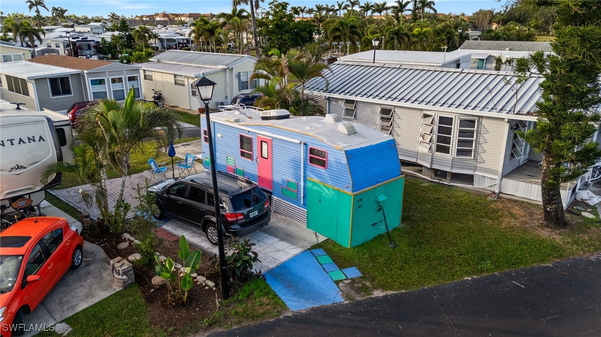 a view of a house with a yard and sitting area