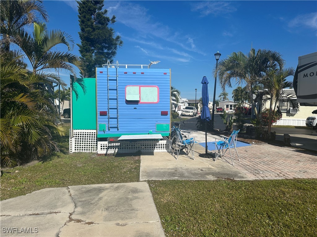 11741 Bubble Shell Drive Fort Myers, FL 33908 - Photo 7 of 11 a building exterior with stairs and furniture