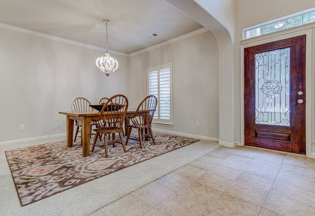 507 Rummel Ranch Run Cedar Park, TX 78613 - Photo 29 of 39 A graceful chandelier illuminates the formal dining space, offering an elegant entry into the home.