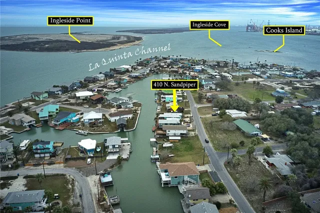 an aerial view of a house with swimming pool and a yard