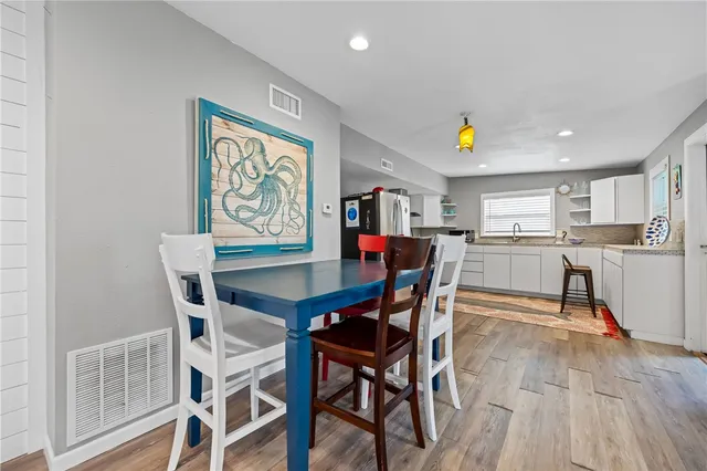 a view of a dining room with furniture and a kitchen