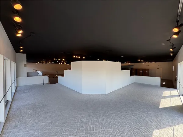 an empty room with closet area and mirror