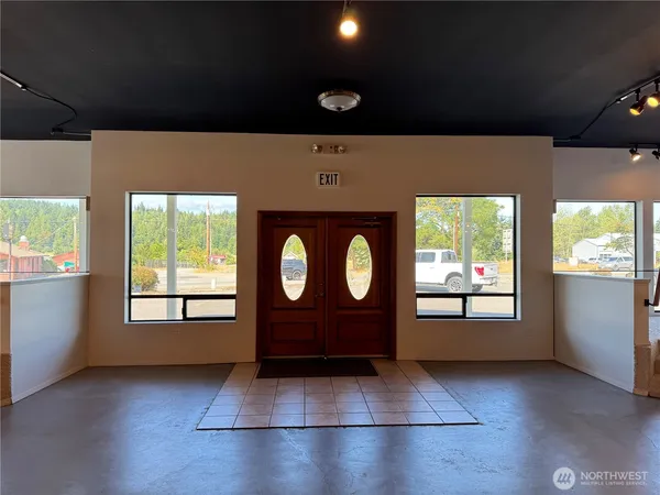 a view of an empty room with a window and a fireplace