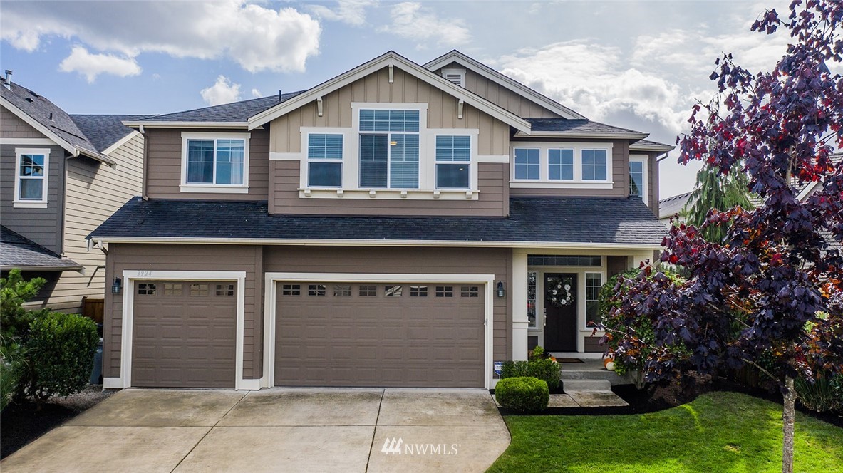 3924 185th Place Southeast Bothell, WA 98012 - Photo 1 of 25 a front view of a house with a yard and garage