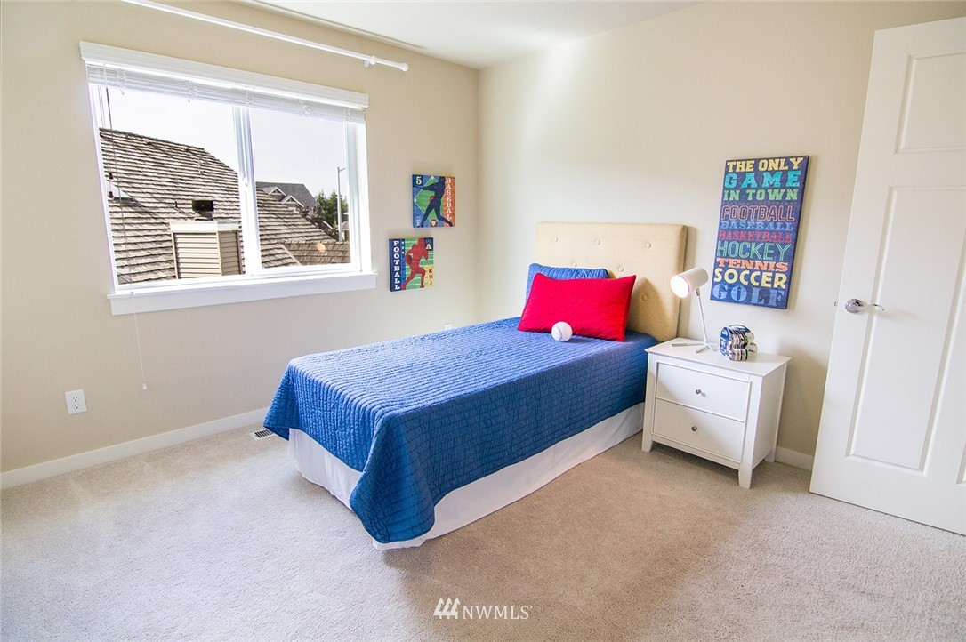 3924 185th Place Southeast Bothell, WA 98012 - Photo 15 of 25 a bedroom with a bed and a large window