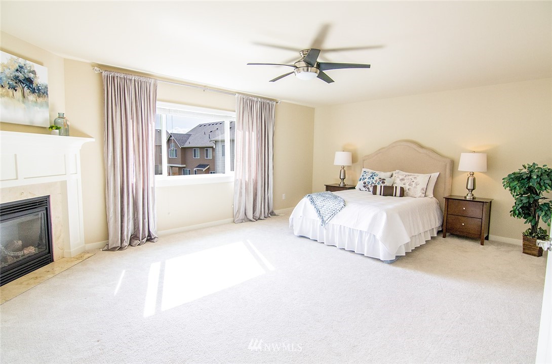 3924 185th Place Southeast Bothell, WA 98012 - Photo 16 of 25 a bedroom with a large bed and a chandelier