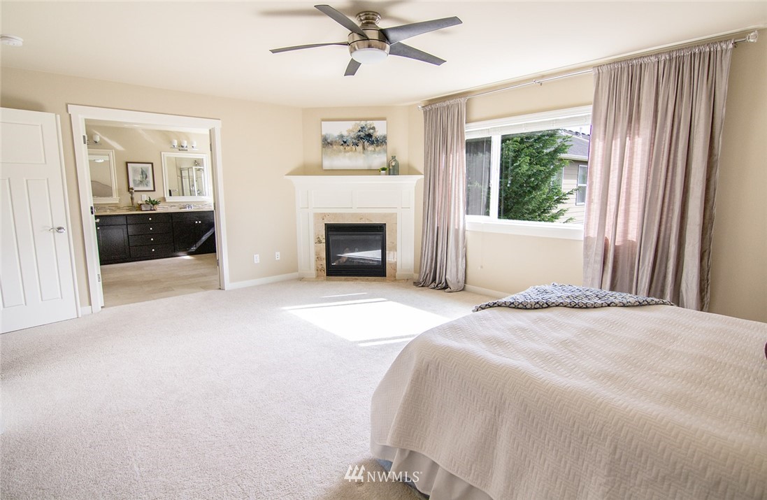3924 185th Place Southeast Bothell, WA 98012 - Photo 17 of 25 a bedroom with a bed and a fireplace