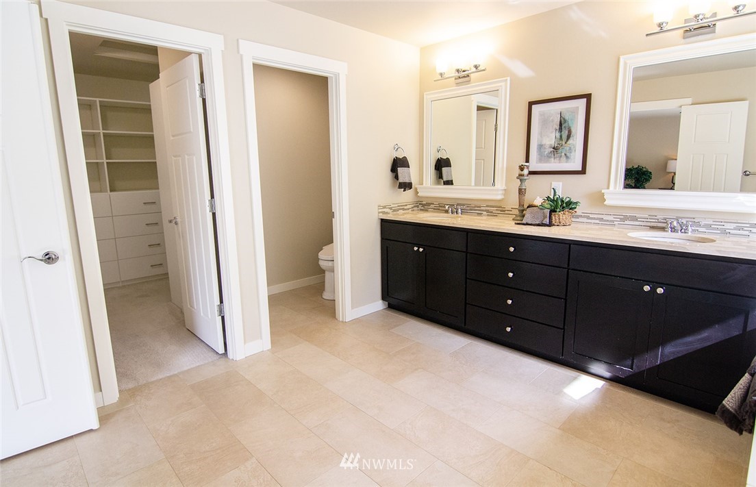 3924 185th Place Southeast Bothell, WA 98012 - Photo 19 of 25 a spacious bathroom with a sink and a mirror