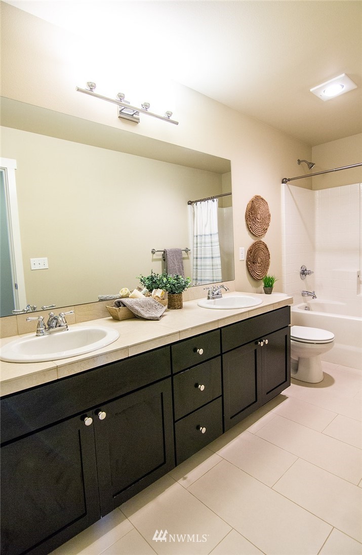 3924 185th Place Southeast Bothell, WA 98012 - Photo 21 of 25 a bathroom with a double vanity sink and a mirror