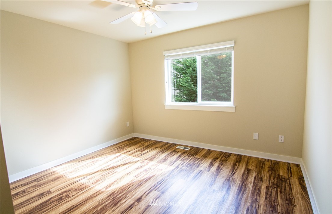 3924 185th Place Southeast Bothell, WA 98012 - Photo 22 of 25 a view of an empty room with wooden floor and a window