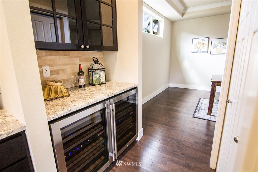 3924 185th Place Southeast Bothell, WA 98012 - Photo 6 of 25 a kitchen with granite countertop a stove and a wooden floor
