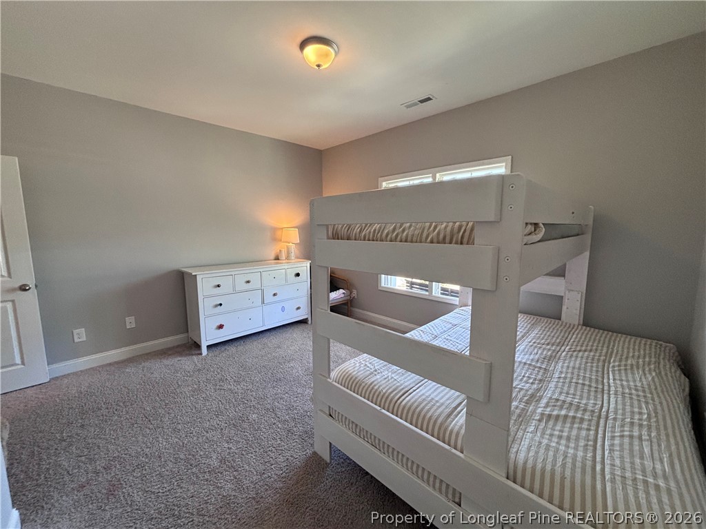 7720 Rufus Johnson Road Fayetteville, NC 28306 - Photo 7 of 50 a bedroom with a bed and a couch