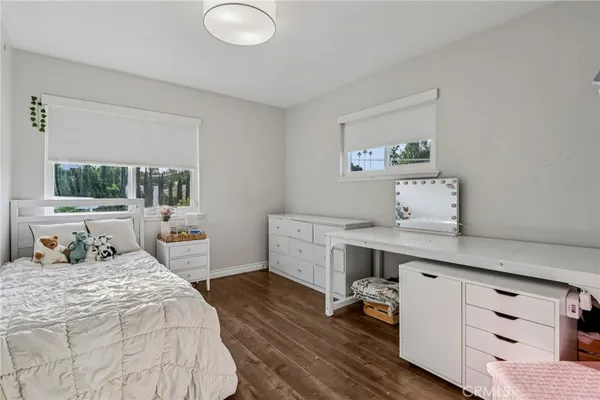 a spacious bedroom with a bed and a chandelier