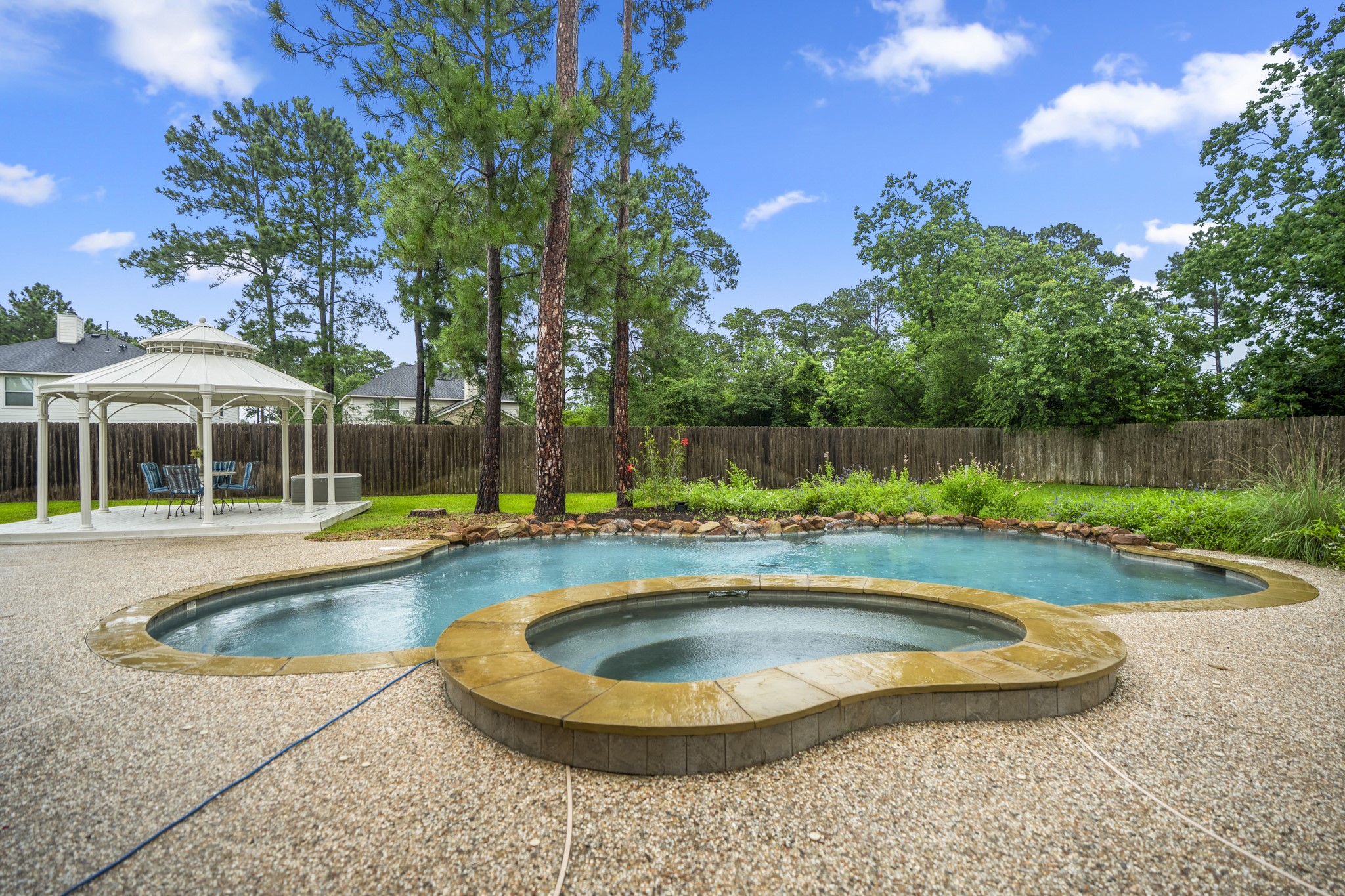 6311 Sparrows Glen Lane Spring, TX 77379 - Photo 33 of 50 This is the backyard lifestyle buyers are going to remember—pool days that turn into dinner under the gazebo, spa nights beneath the trees, and wildflower beds designed to bring seasonal butterflies and hummingbirds into view.