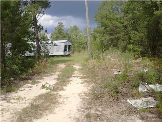1213 Delaware Road DeFuniak Springs, FL 32433 - Photo 1 of 4 a view of a house with a yard
