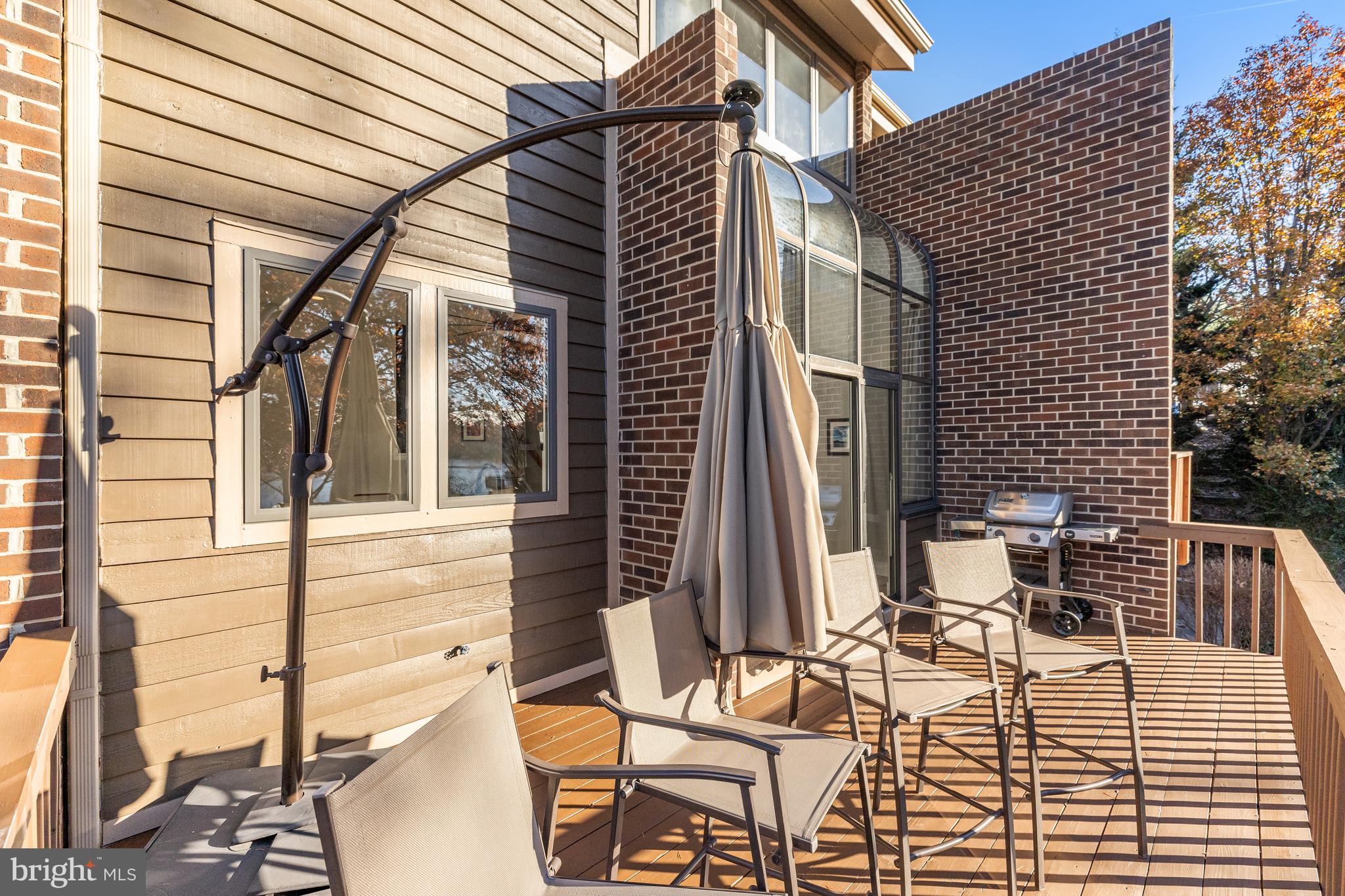 11010 Thrush Ridge Road Reston, VA 20191 - Photo 17 of 87 a view of a patio with table and chairs and wooden floor