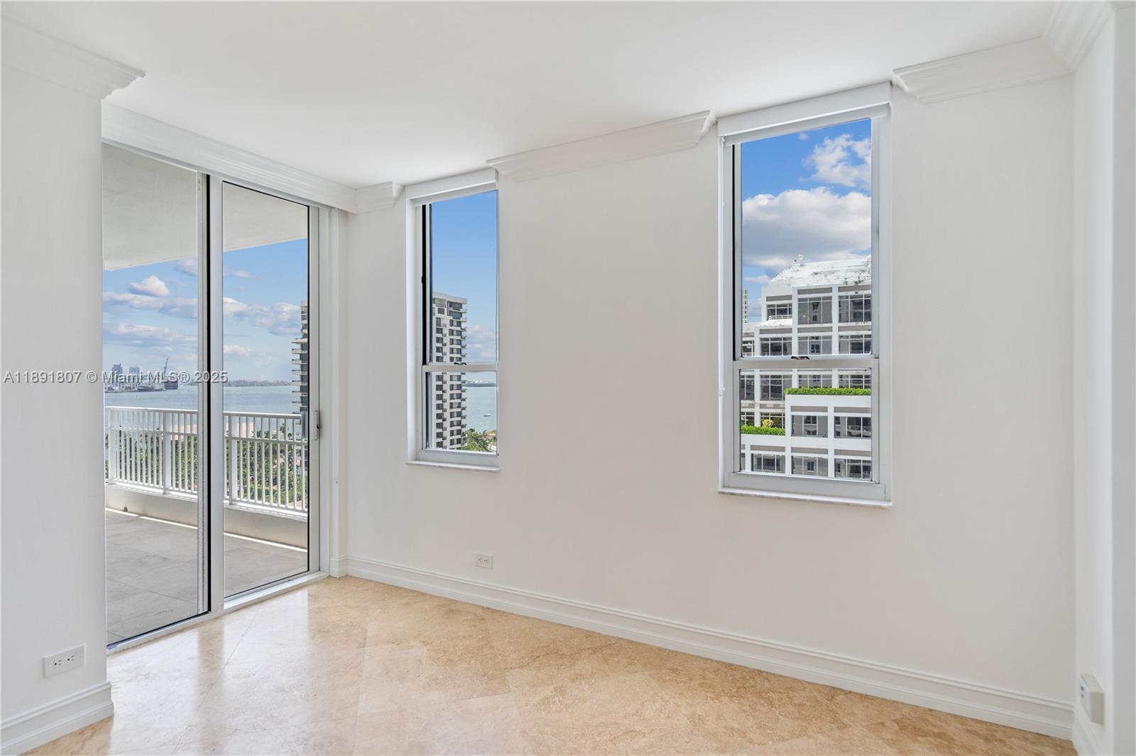 701 Brickell Key Boulevard, Unit 1411 Miami, FL 33131 - Photo 11 of 20 an empty room with windows and entrance