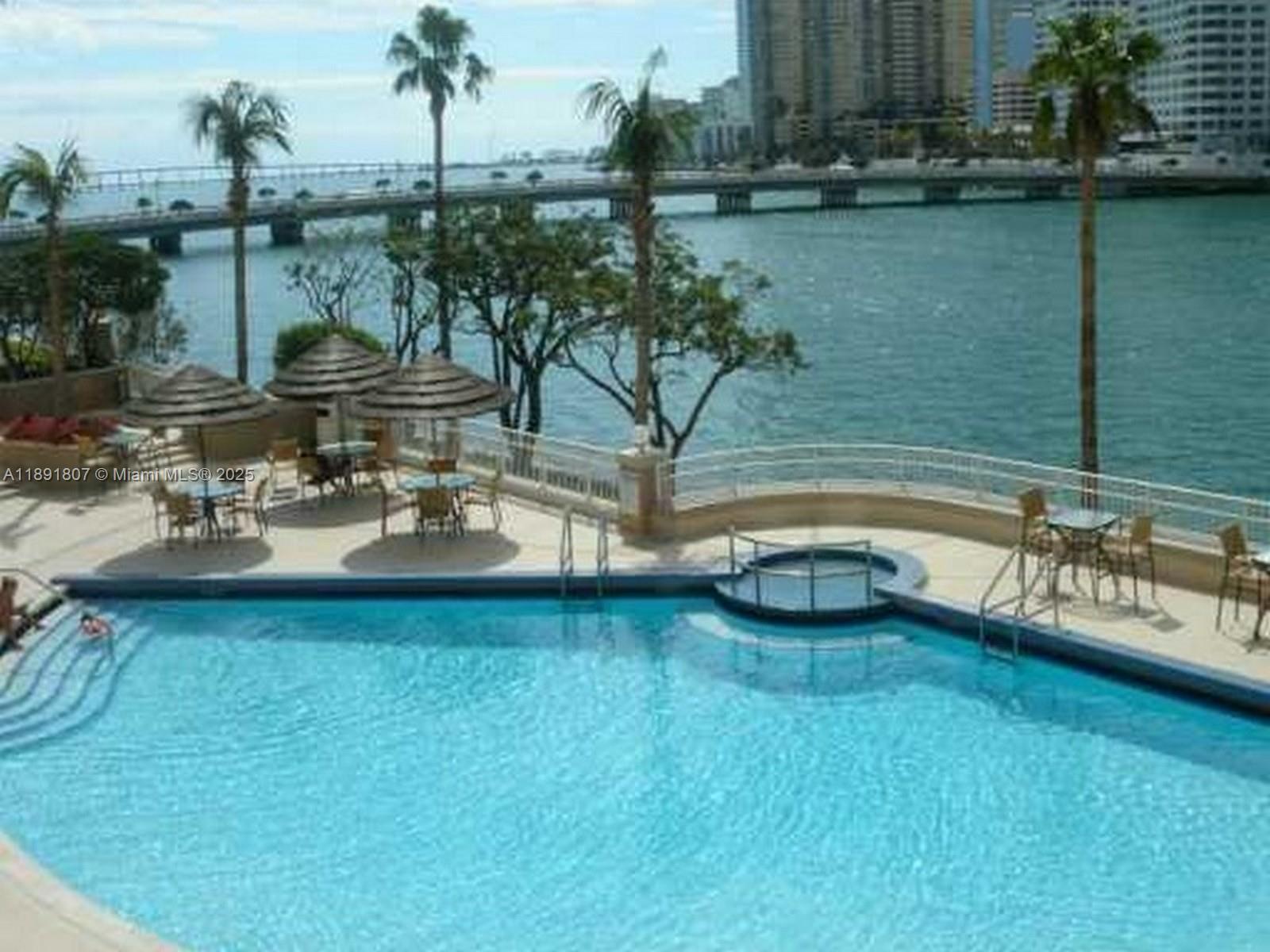 701 Brickell Key Boulevard, Unit 1411 Miami, FL 33131 - Photo 17 of 20 a view of a lake with couches and wooden floor