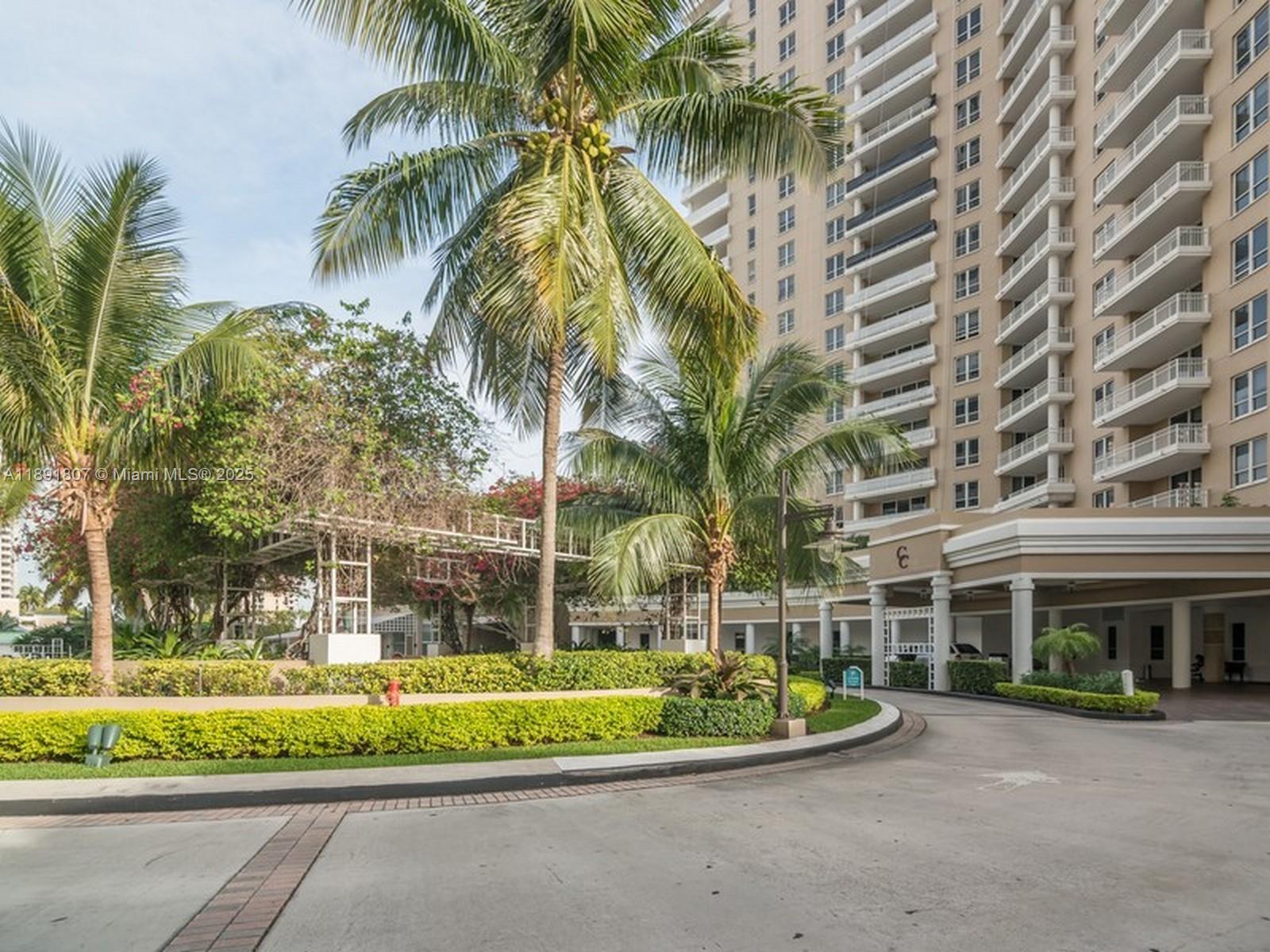 701 Brickell Key Boulevard, Unit 1411 Miami, FL 33131 - Photo 18 of 20 a view of swimming pool with a garden and trees