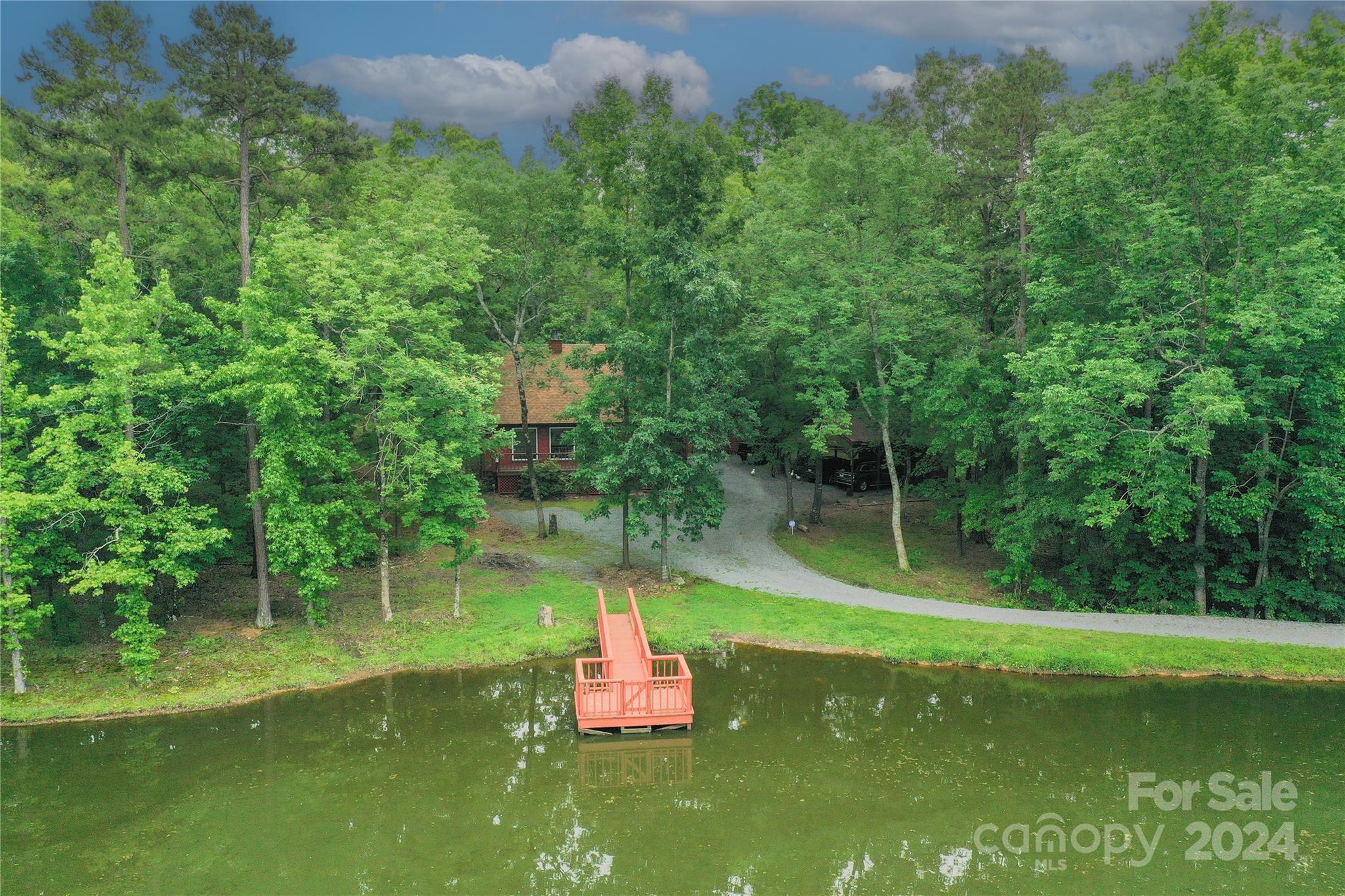 7020 Shelf Road Marshville, NC 28103 - Photo 42 of 45 a backyard of a house with lots of green space and lake view